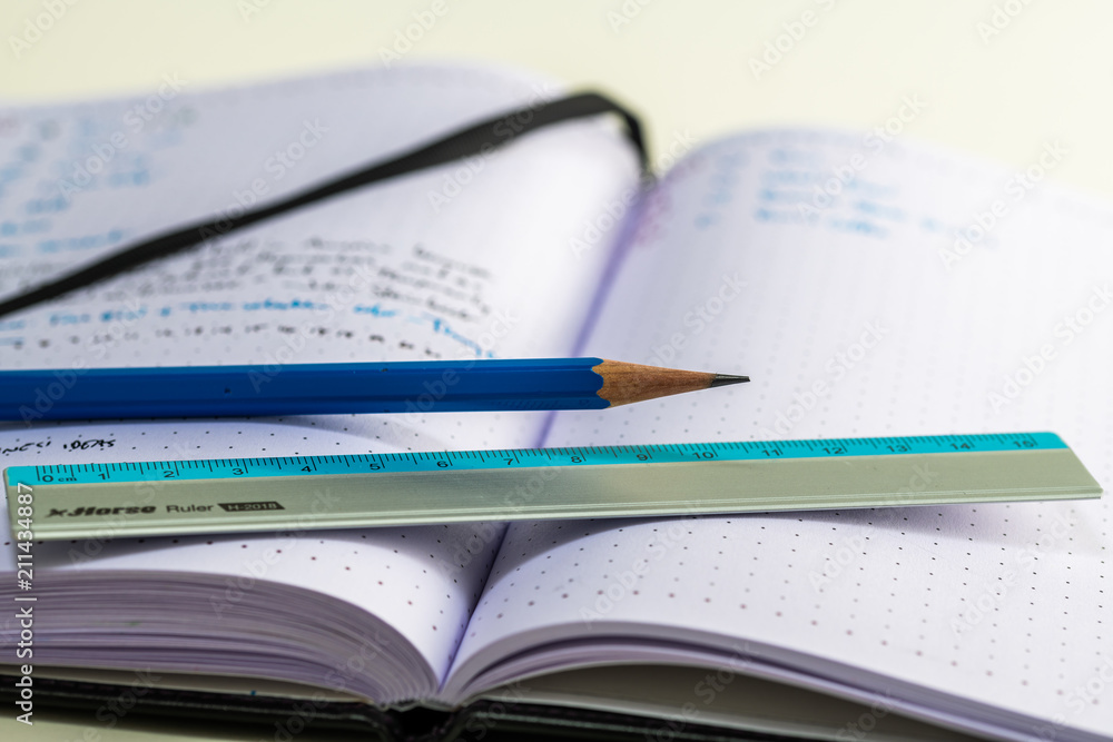 Notebook with writing, ruler, pencil, fountain pen Notebook with writing, ruler, pencil, fountain pen