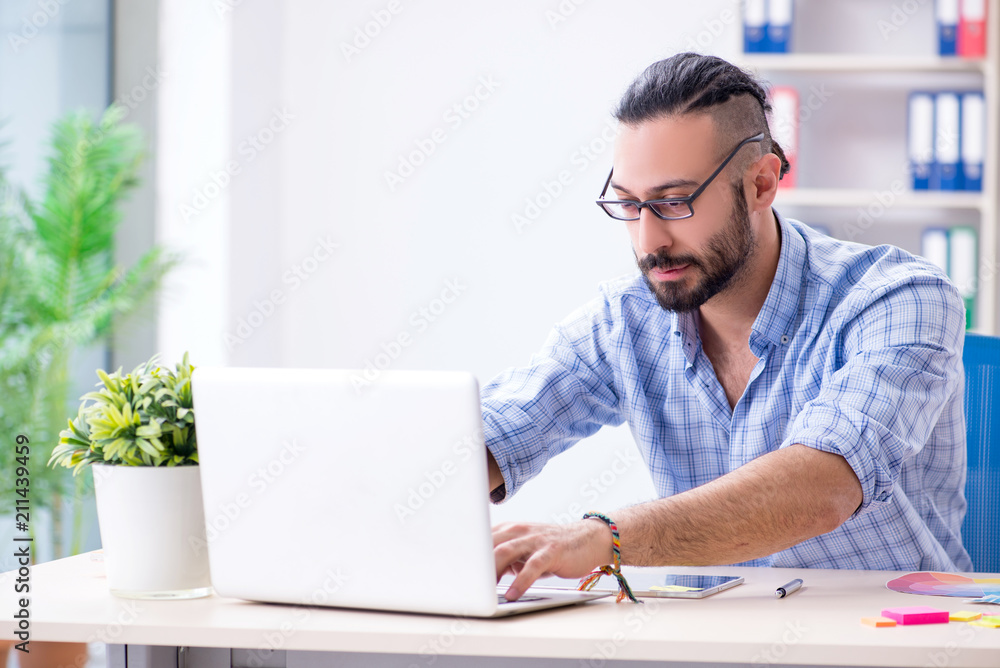 Young designer working in his studio on new project Young designer working in his studio on new project