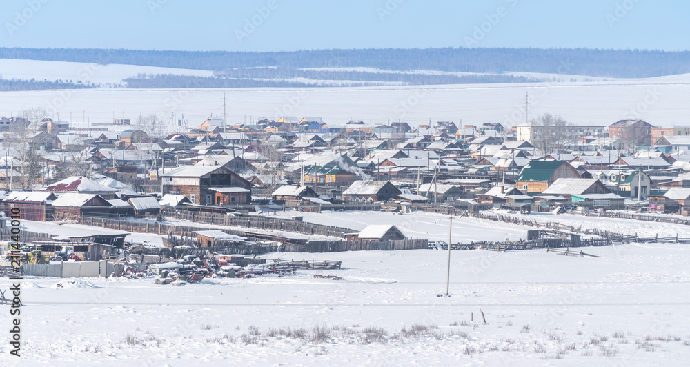 Small village in winter on the island at frozen lake Baikal in Siberia, Russia
