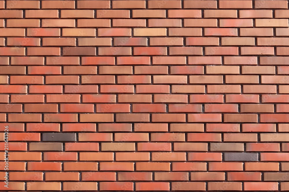 wall of colored bricks with different step of laying