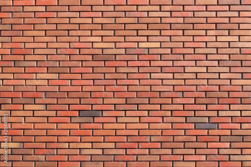 wall of colored bricks with different step of laying