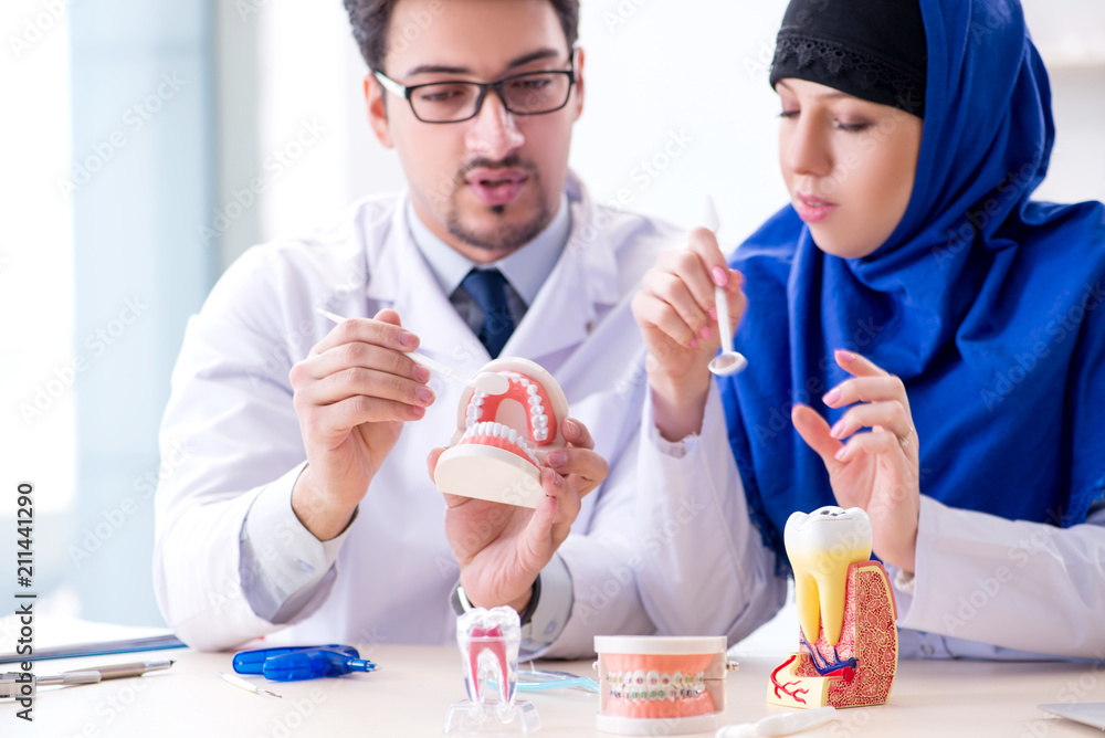 Dentist doctor and assistant working on new tooth implant Dentist doctor and assistant working on new tooth implant