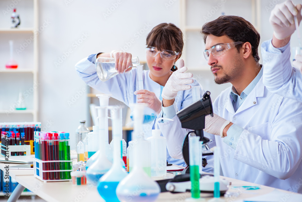 Team of chemists working in the lab Team of chemists working in the lab