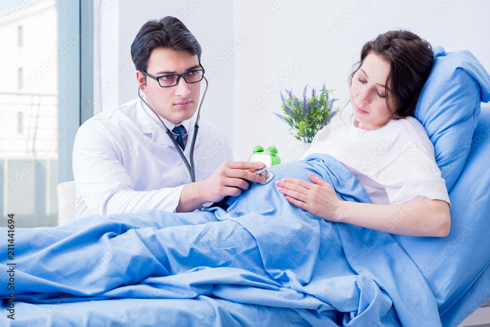 Doctor visiting pregnant in hospital room Doctor visiting pregnant in hospital room