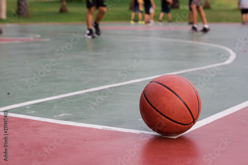 Basketball ball on corner of the outdoors court