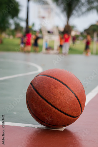 Basketball ball on corner of the outdoors court