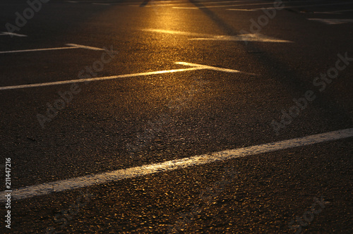 image of empty parking lot during sunset. asphalt background.