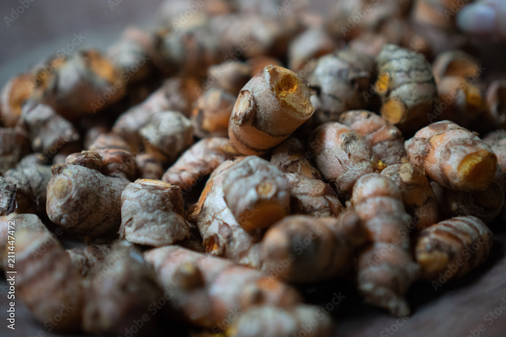 Closeup dried galangal on the rustic clay brown plate Closeup dried galangal on the rustic clay brown plate