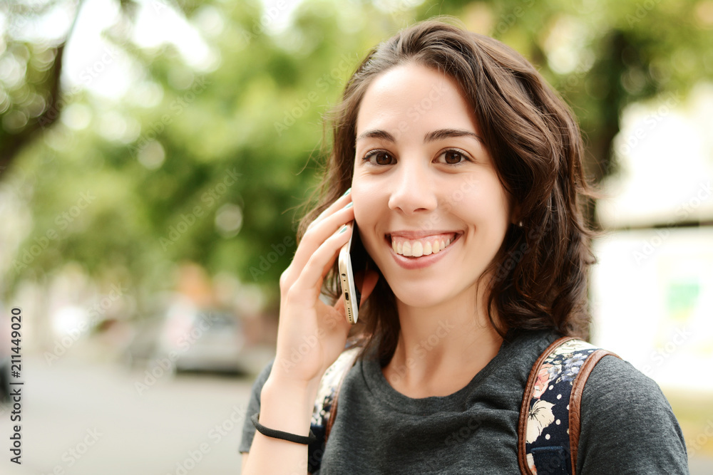 Young woman talking on her mobile phone. Young woman talking on her mobile phone.