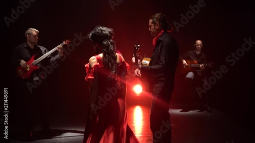 Girl dancing flamenco dance. Light from behind