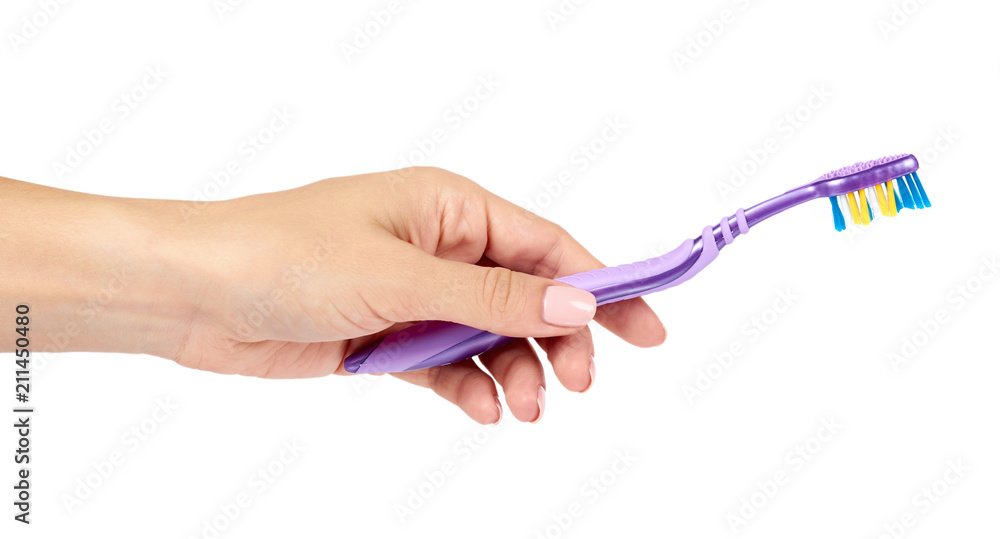 Color new toothbrush with hand isolated on a white background. Color new toothbrush with hand isolated on a white background.