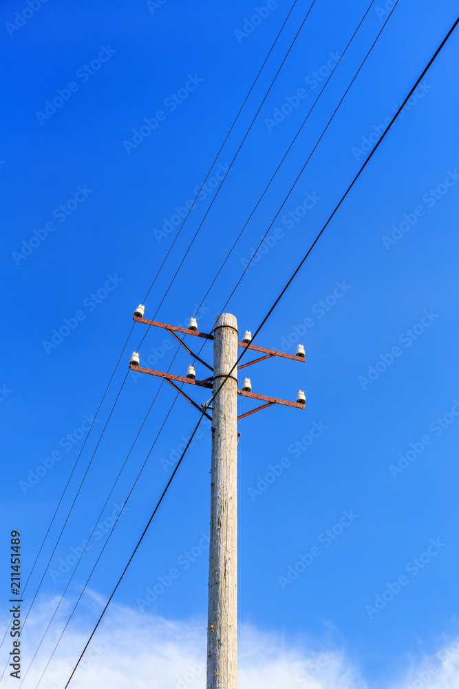 Telephone pole with wires against a blue sky Telephone pole with wires against a blue sky