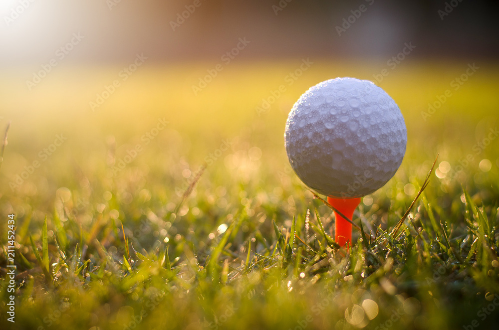 Golf ball with warm sunlight and raining at sunset Golf ball with warm sunlight and raining at sunset