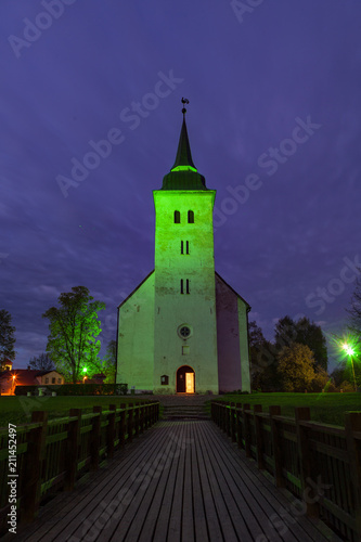 Beautiful bright green artificial light over church in Viljandi, Estonia.
