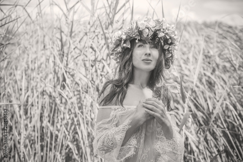 Mermaid. Beauty girl with nymphaea at lace dress. Midsummer. Portrait of slavic or baltic woman near reeds. Summer 