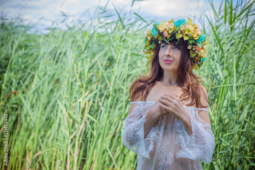 Mermaid. Beauty girl with nymphaea at lace dress. Midsummer. Portrait of slavic or baltic woman near reeds. Summer 