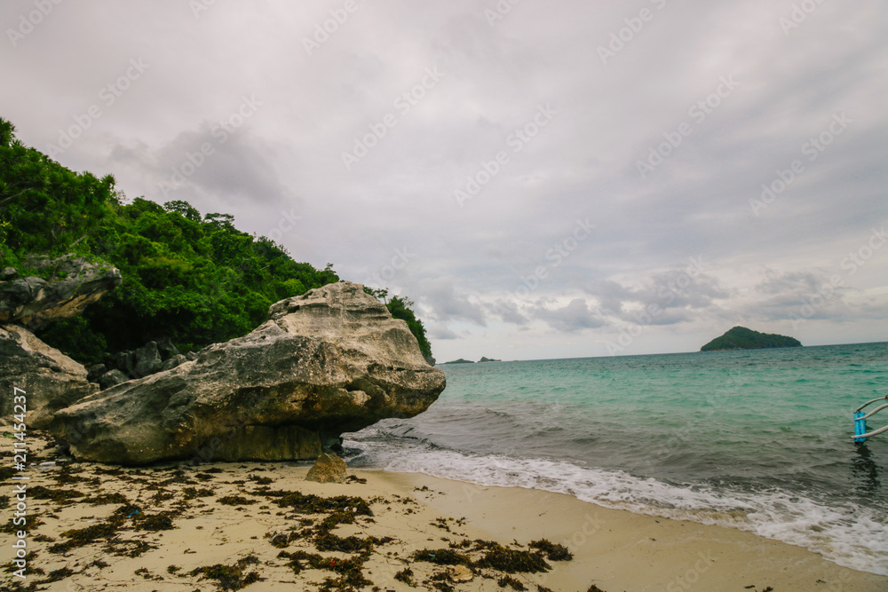Man standing on the edge of the cliff in an deserted island. Man standing on the edge of the cliff in an deserted island.