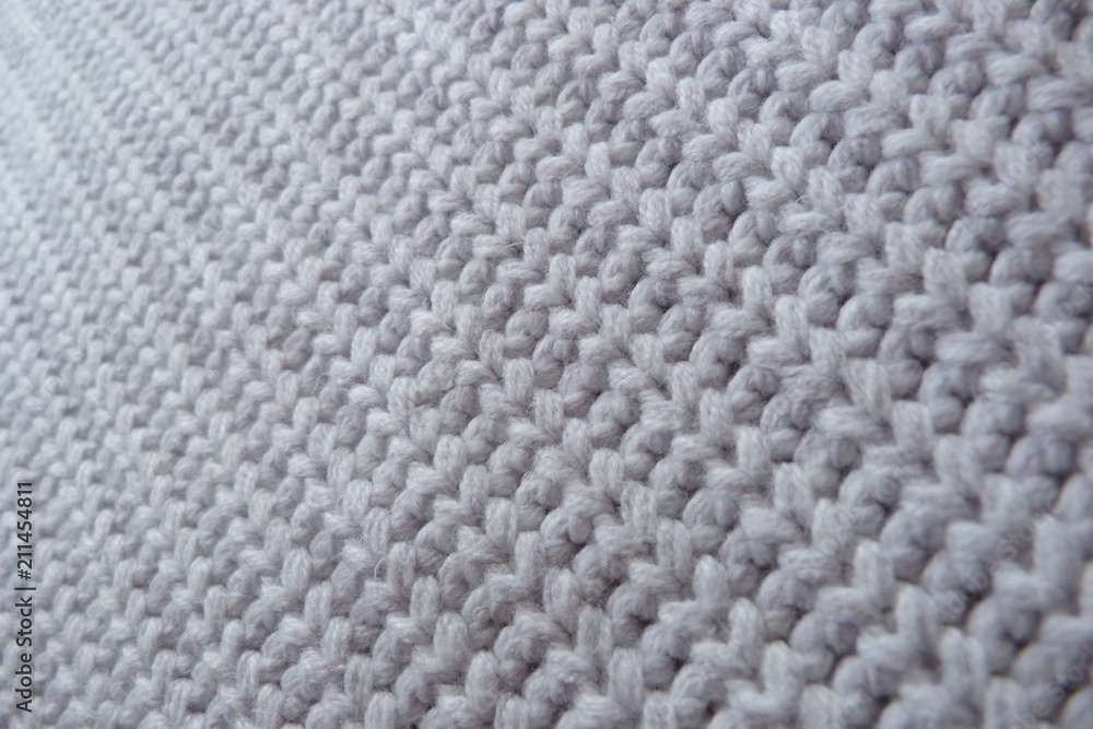 knitted knitted fabric close-up fine-wool from a wool of large mating handmade natural material textured background for a décor knitted knitted fabric close-up fine-wool from a wool of large mating handmade natural material textured background for a décor