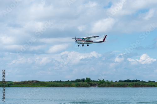 A small plane flying above the lake