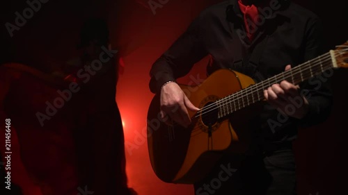 Girl dancing flamenco dance. Light from behind. smoke background