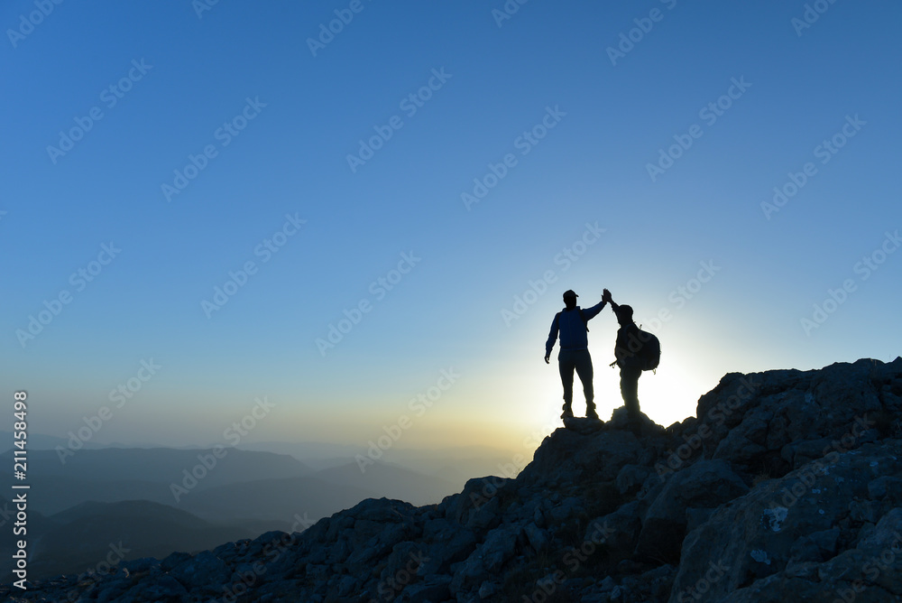 Couple hikers success concept in mountains Couple hikers success concept in mountains