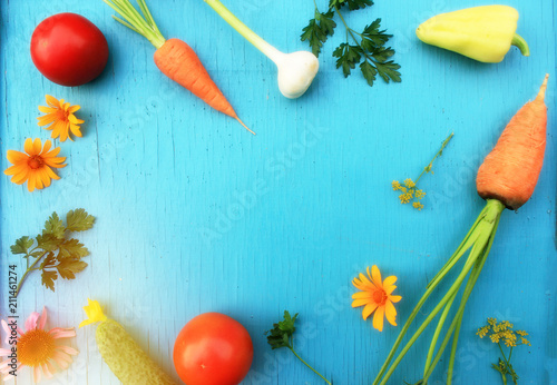 Harvested vegetables (carrot, tomatoes, cucumber, pepper, parsley, young garlic): nutrient-rich foods concept, top view background with copy space