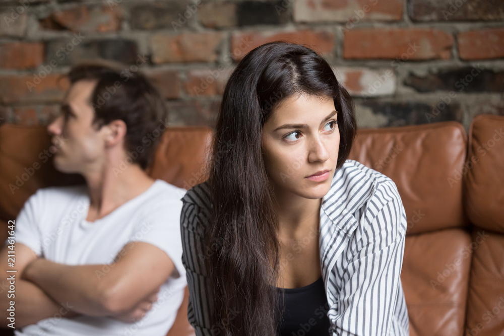 Angry unhappy young couple ignoring not looking at each other after family fight or quarrel, upset thoughtful spouses avoiding talk, sitting silently on couch, having relationship troubles. Angry unhappy young couple ignoring not looking at each other after family fight or quarrel, upset thoughtful spouses avoiding talk, sitting silently on couch, having relationship troubles.