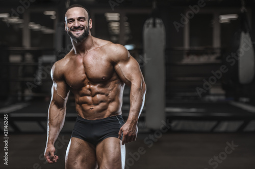 Brutal strong bodybuilder athletic men pumping up muscles with dumbbells