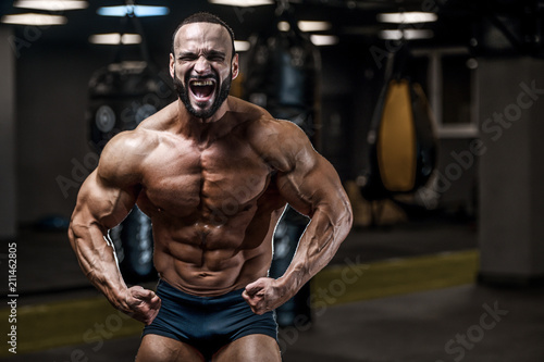 Brutal strong bodybuilder athletic men pumping up muscles with dumbbells