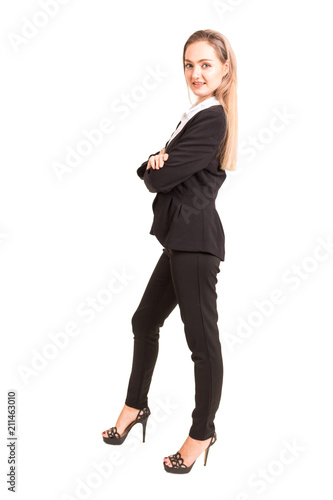 Portrait of smiling businesswoman in black suit standing isolated on white background