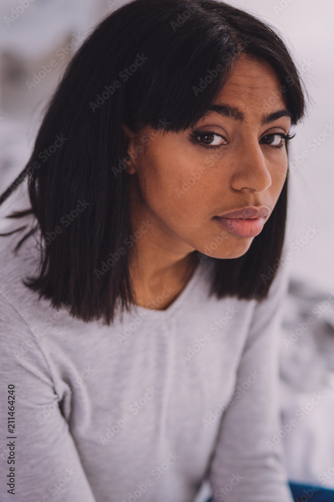 International femininity. Young female being at home while looking straight at camera International femininity. Young female being at home while looking straight at camera
