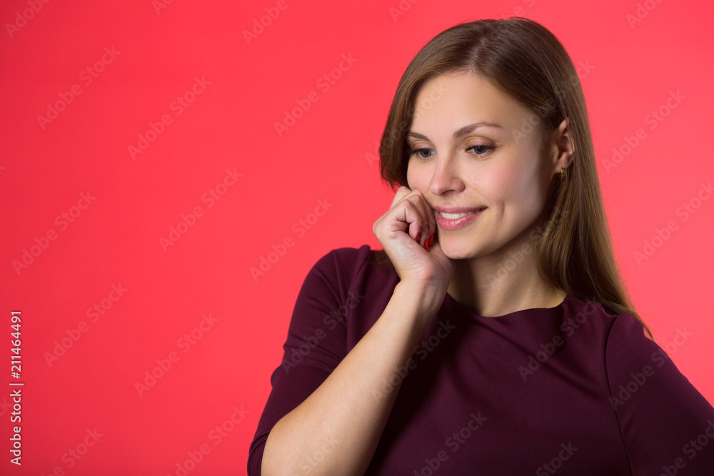 Fototapeta premium beautiful young girl with her hair on a red background