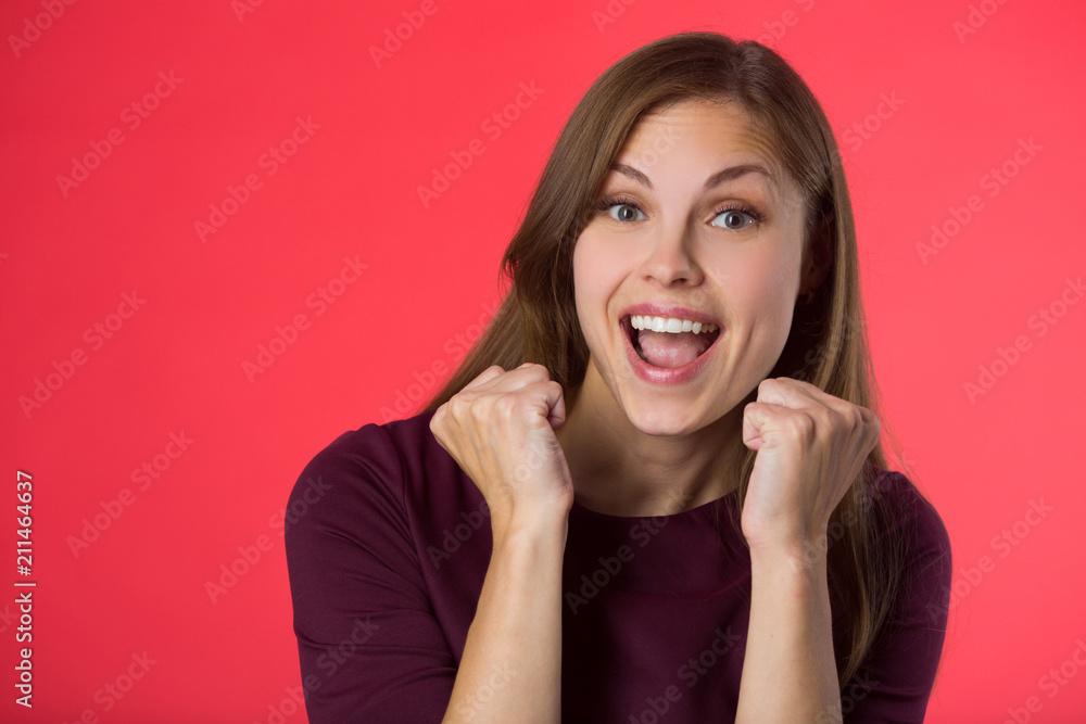 beautiful young girl with her hair on a red background beautiful young girl with her hair on a red background