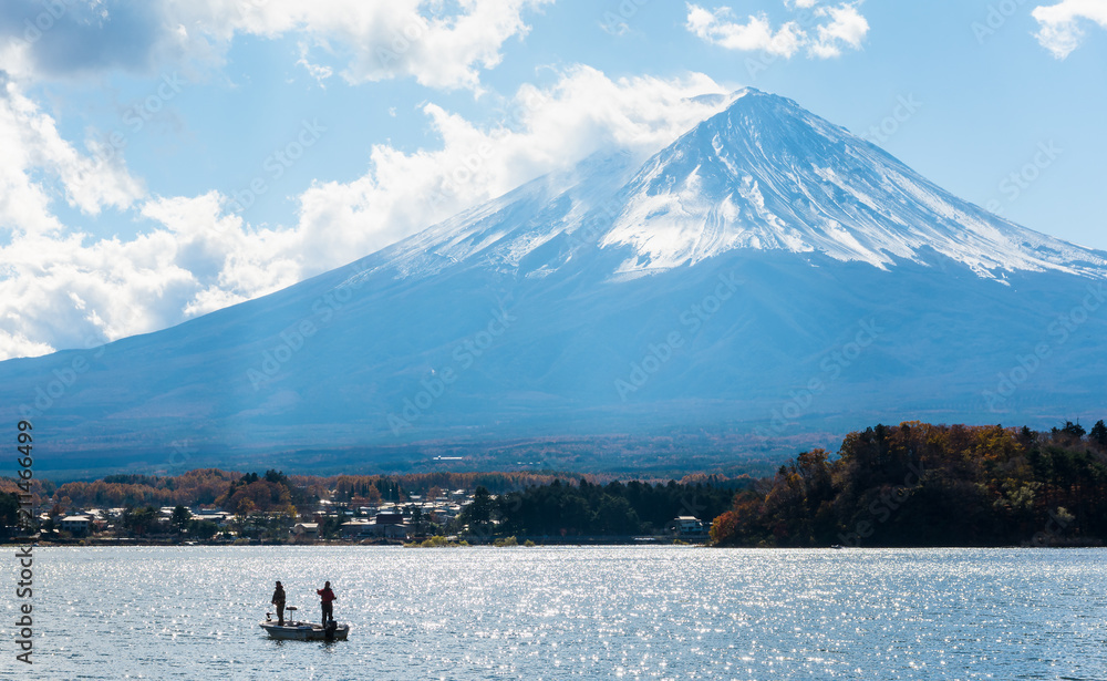 fuji mountain with fishing boat and shimmer of sunlight reflecion.