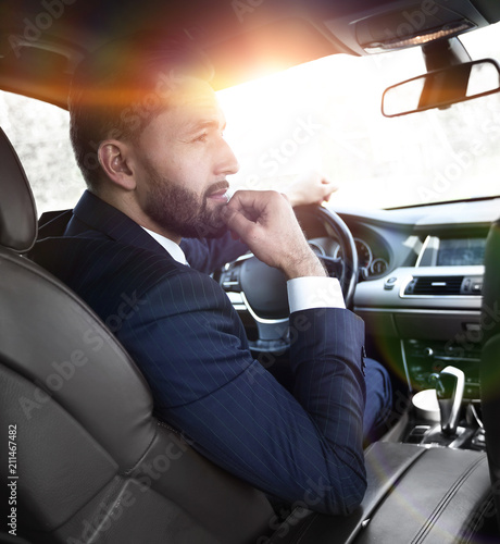 Confident businessman in his car.