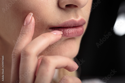 Closeup macro photo of woman's lips with natural lip balm