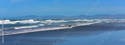 Strong waves battling The Pines Beach in Canterbury, New Zealand
