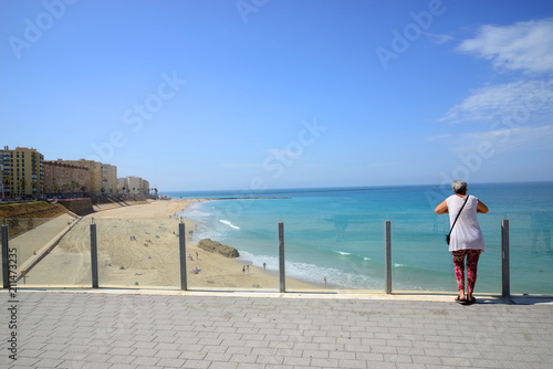 Cádiz, Spain - 21 June 2018: A woman observes the beach at the viewpoint of Cádiz.