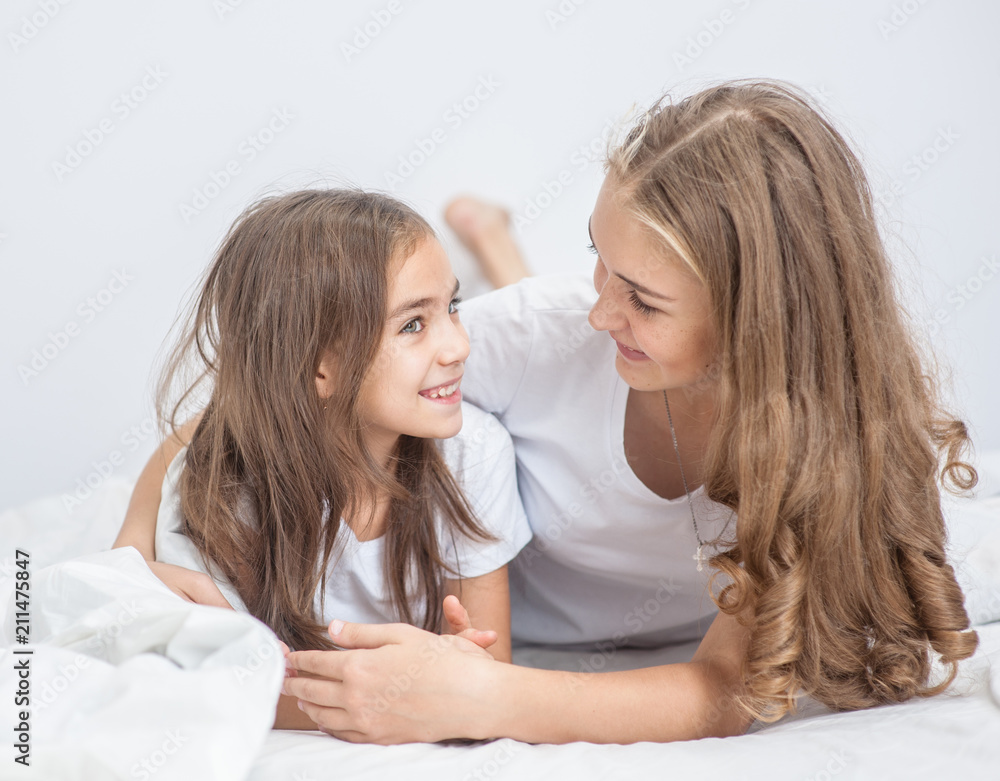 Sisters have fun on the bed Sisters have fun on the bed