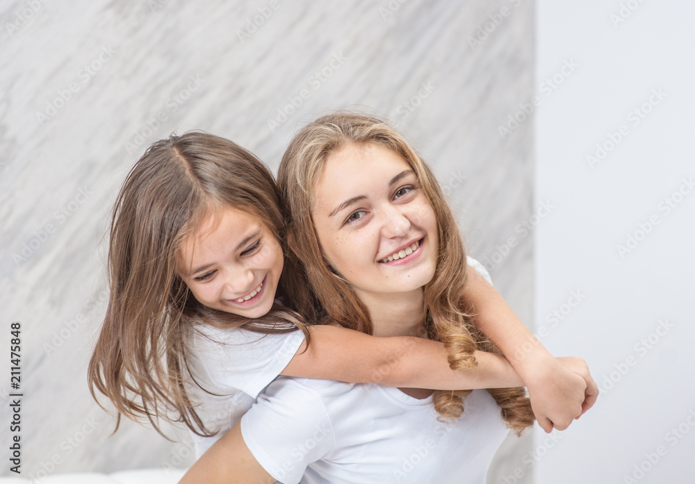 Happy family - mother and daughter have fun on the bed Happy family - mother and daughter have fun on the bed