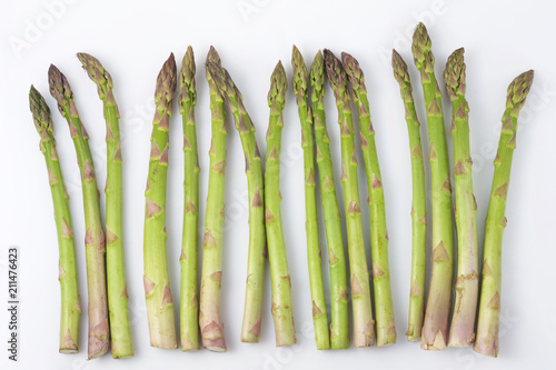 sprouts of green asparagus on a white background