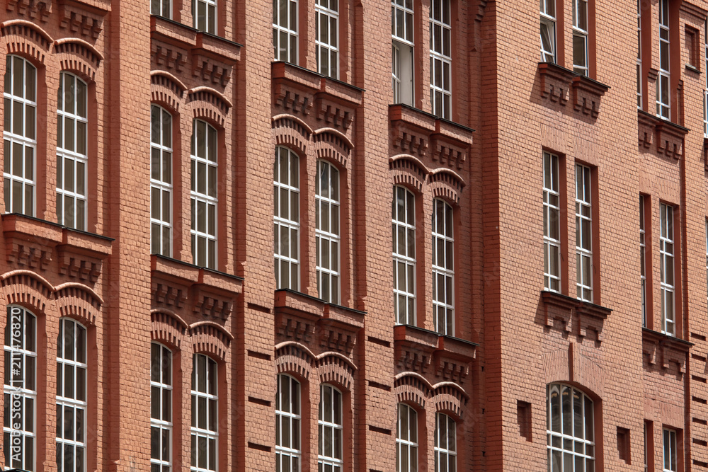 Windows in a multi-storey brick building as a background