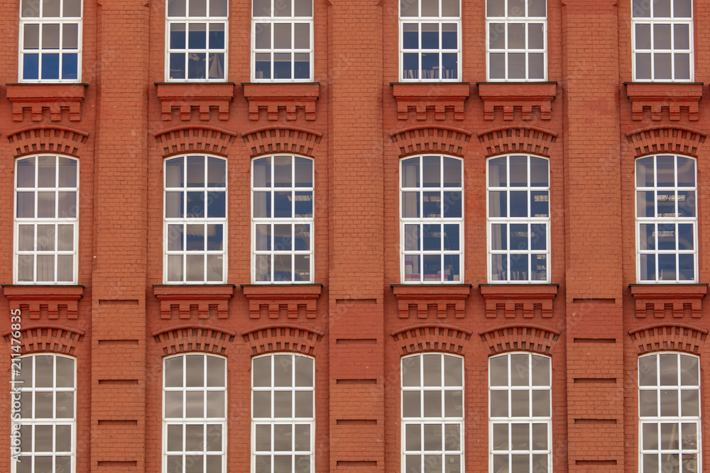Windows in a multi-storey brick building as a background