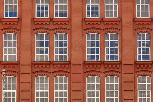 Windows in a multi-storey brick building as a background