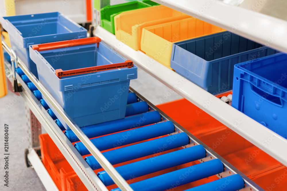 Fototapeta premium Plastic boxes on the roller conveyor.