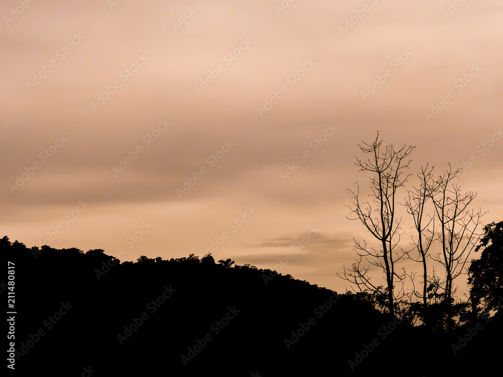silhouette image - sunlight behind the mountain at sunrise
