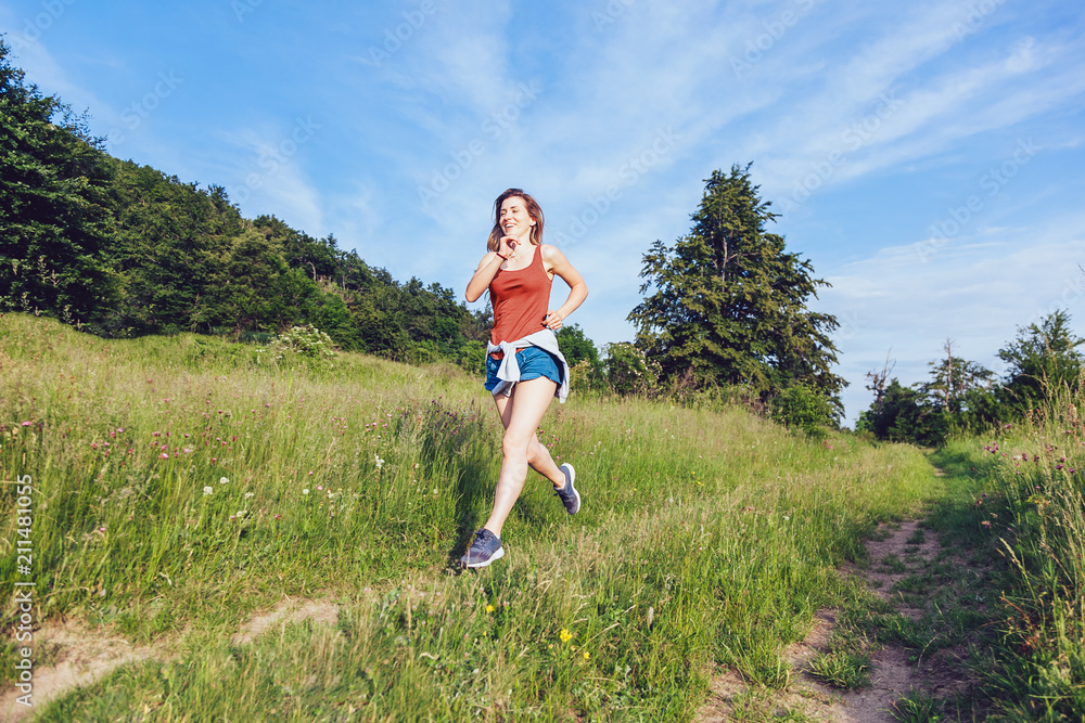 Young woman jogging in the nature at sunset Young woman jogging in the nature at sunset