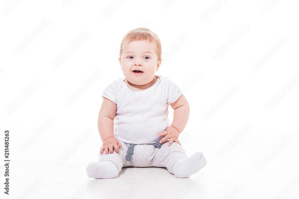 smiling baby sitting on a floor smiling baby sitting on a floor
