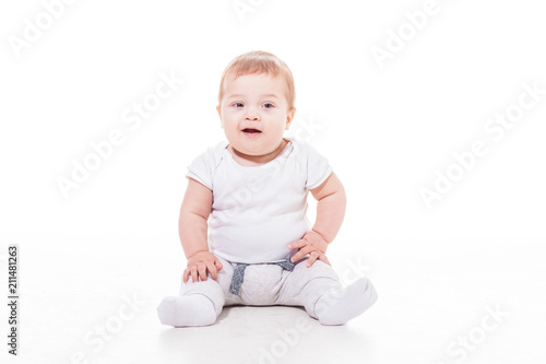 smiling baby sitting on a floor