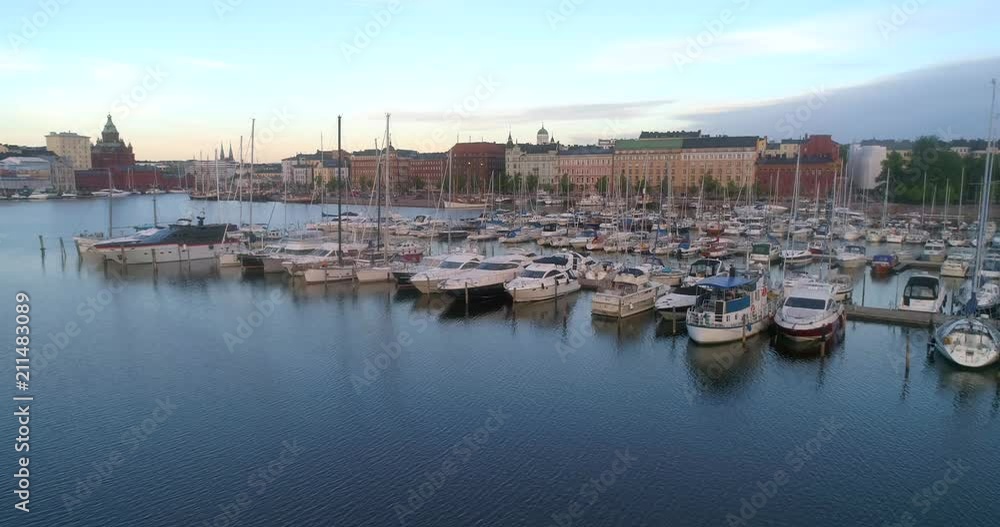 Boats at a harbour, C4k aerial view of the harbor in Kruununhaka, on a sunny summer morning dawn, in Helsinki, Uusimaa, Finland Boats at a harbour, C4k aerial view of the harbor in Kruununhaka, on a sunny summer morning dawn, in Helsinki, Uusimaa, Finland